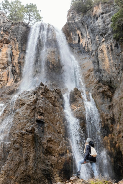 Free photo woman in nature at waterfall