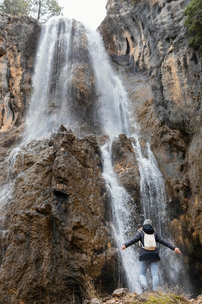 Woman in nature at waterfall