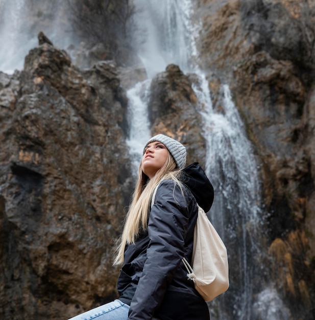 Free photo woman in nature at waterfall