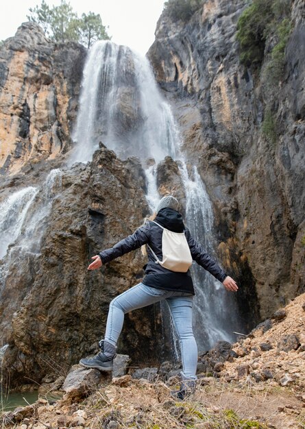 Woman in nature at waterfall