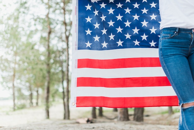 Free photo woman in nature with american flag and copyspace