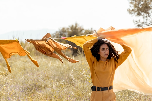 Free photo woman in nature with clothesline