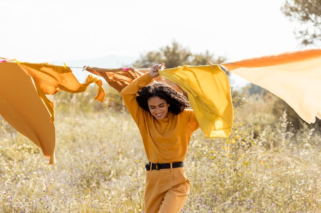 Free photo woman in nature with clothesline