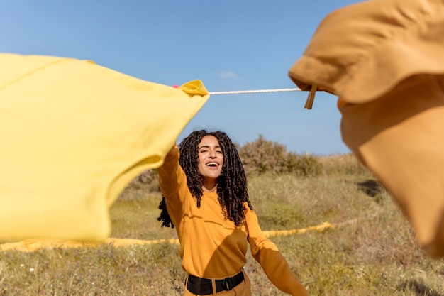 Free photo woman in nature with clothesline