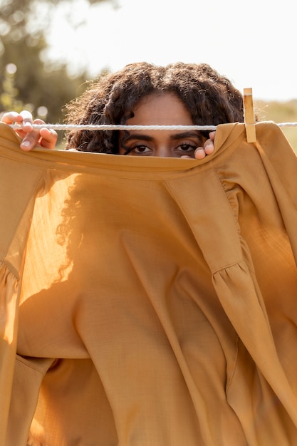 Free photo woman in nature with clothesline