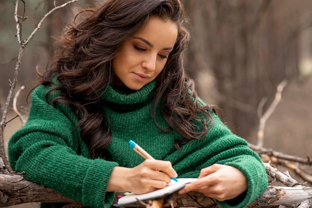 Free Photo woman in nature writing