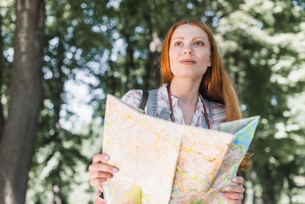 Free Photo woman navigating with map