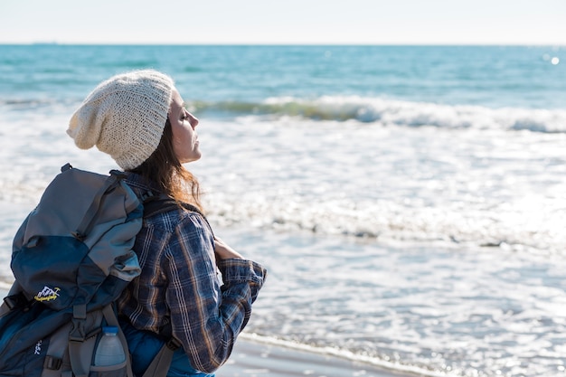 Free photo woman near ocean enjoying breeze