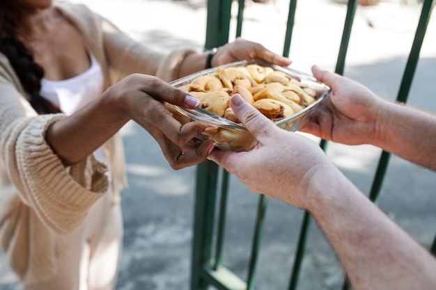 Free photo woman offering food to neighbor