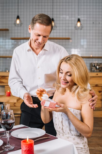 Woman opening a present from her lover