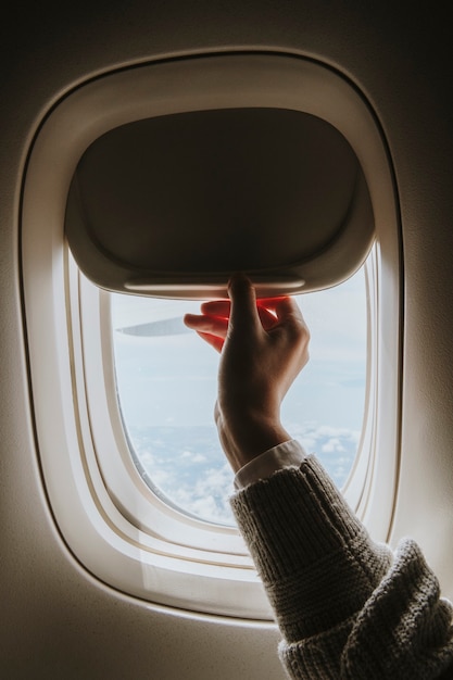 Free photo woman opening a window shade