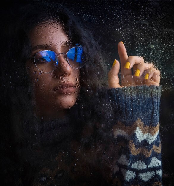 Woman in optique glasses with blue shadow and warm knit jacket