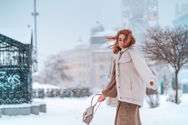 Free photo woman outside on snowing cold winter day