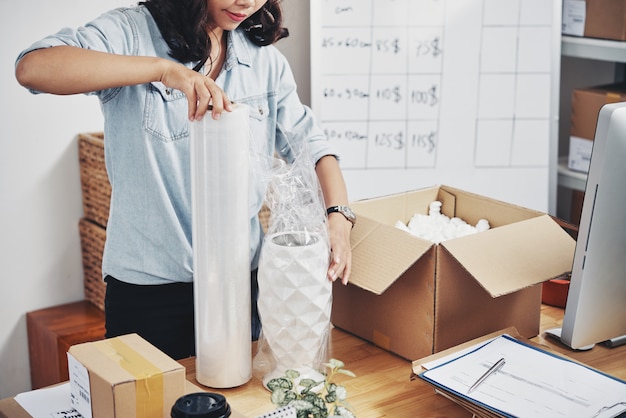 Free photo woman packing order in box