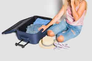 Free photo woman packing suitcase for trip