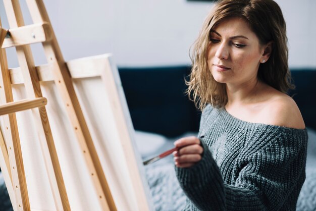 Woman painting on canvas