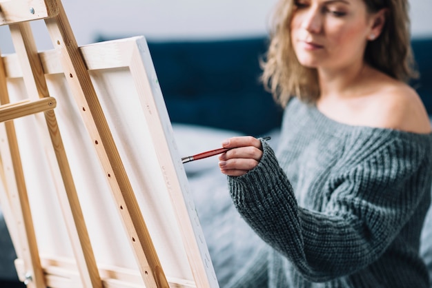 Woman painting in her home