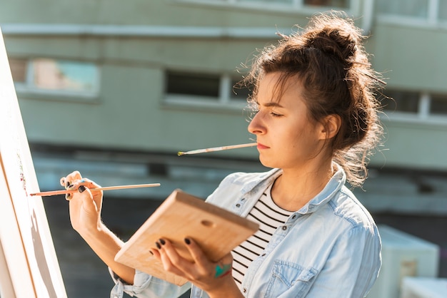 Woman painting outdoors