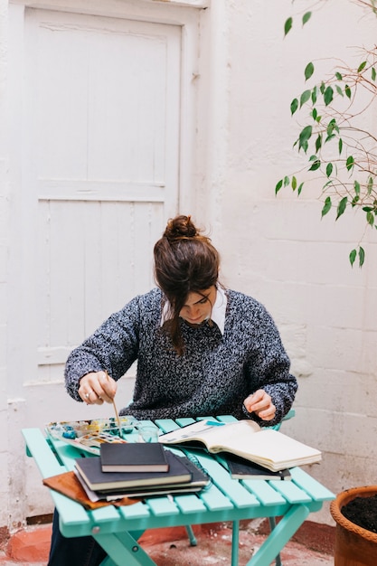 Free Photo woman painting at table