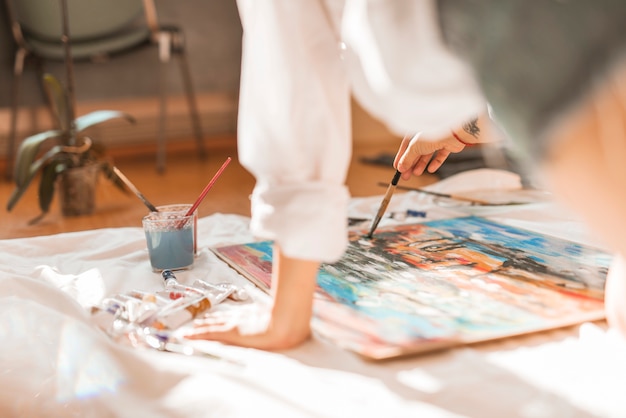 Woman painting with watercolor in studio