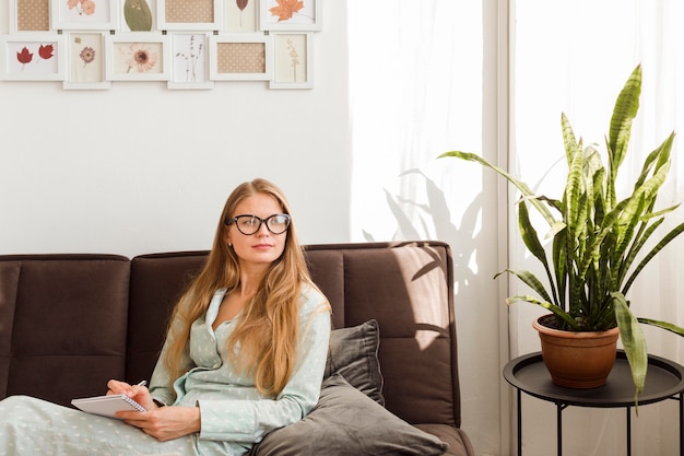 Woman in pajamas working from home