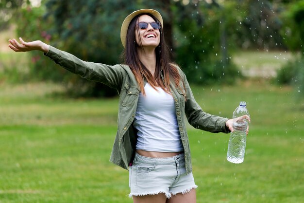 Free Photo woman in park with bottle of water