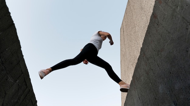 Woman parkouring over buildings