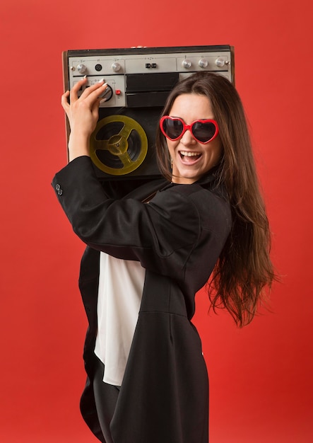 Free Photo woman at party wearing sunglasses with radio