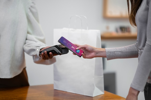 Woman paying with card  side view