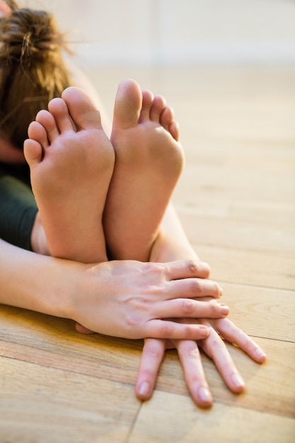 Free Photo woman performing paschimottanasana pose