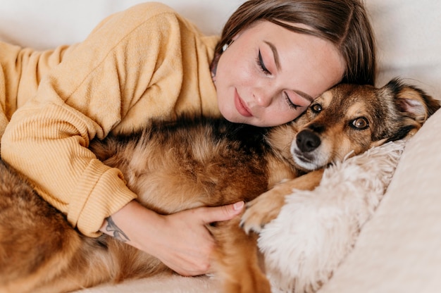 Free Photo woman petting adorable dog