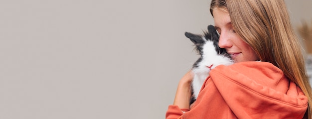 Free Photo woman petting adorable rabbit