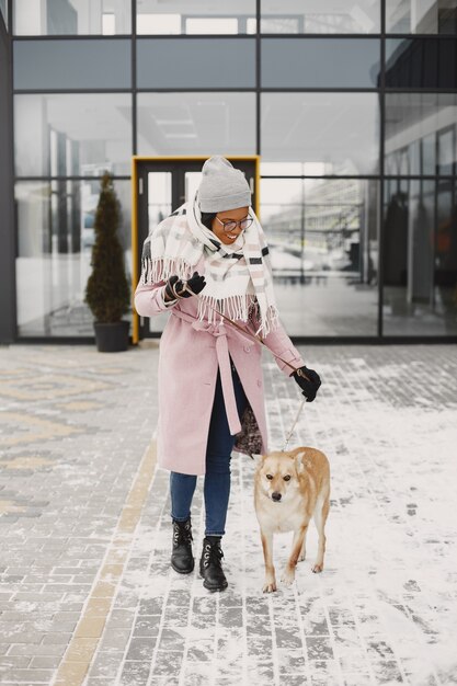 Woman in a pink coat, walking dog