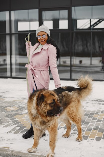 Woman in a pink coat with dog