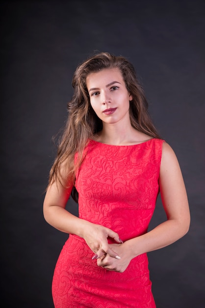 Woman in pink dress looking at camera 