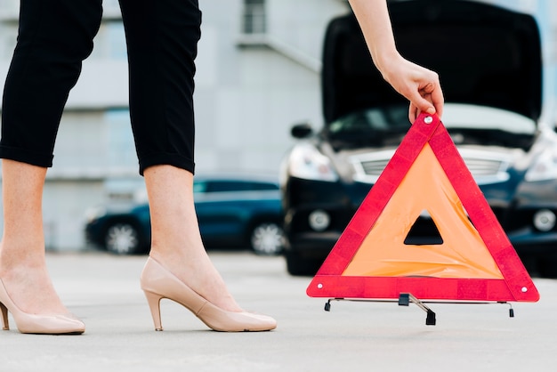 Free photo woman placing emergency sign