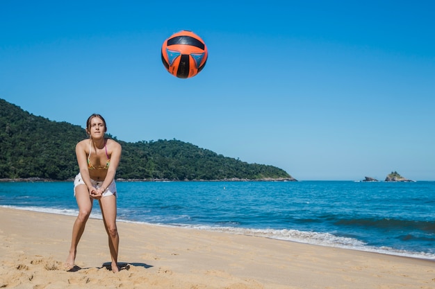 Free Photo woman playing beach volley