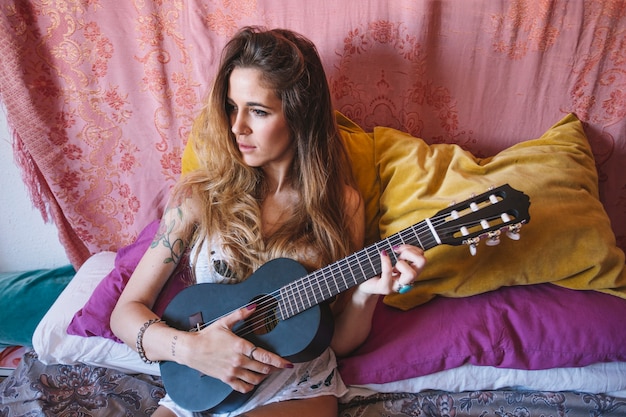 Woman playing black ukulele