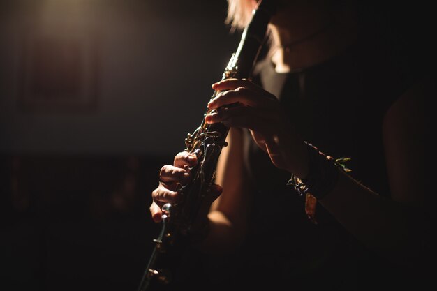 Woman playing a clarinet in music school