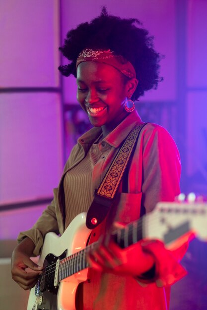 Woman playing the guitar at a local event