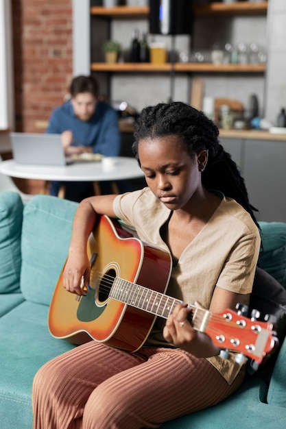 Free Photo woman playing the guitar medium shot