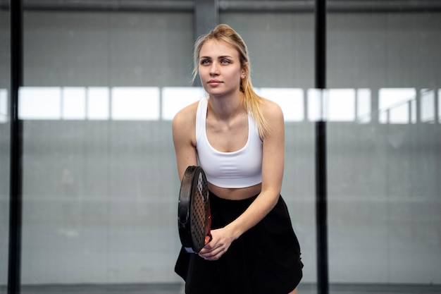 Woman playing paddle tennis front view