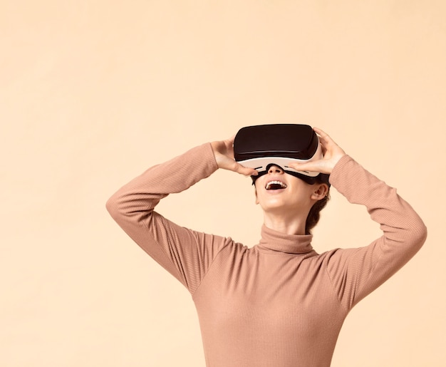 Free photo woman playing on virtual reality headset and looking up