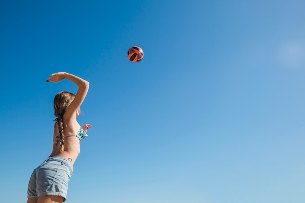 Free photo woman playing volleyball view from below