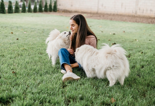 Free photo woman playing with cute dogs