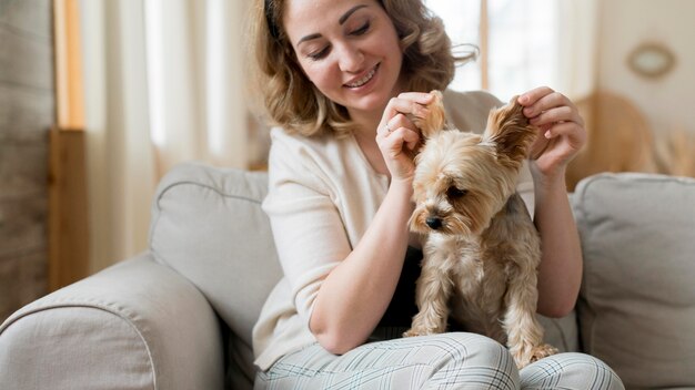 Woman playing with her cute dog