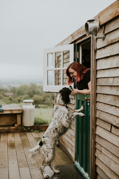 Free photo woman playing with her pet dog