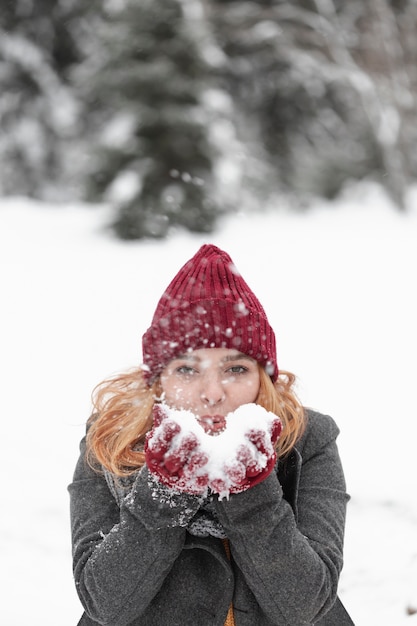 Woman playing with snow outdoors