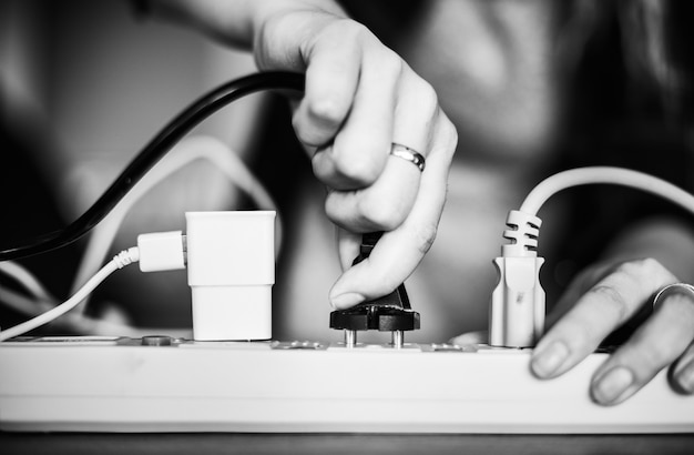 Free photo woman plugging in a wire