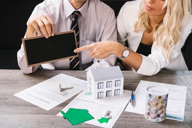 Free photo woman pointing at chalkboard in estate agency